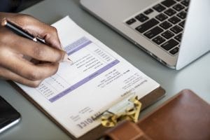 closeup business man checking tax invoice paper